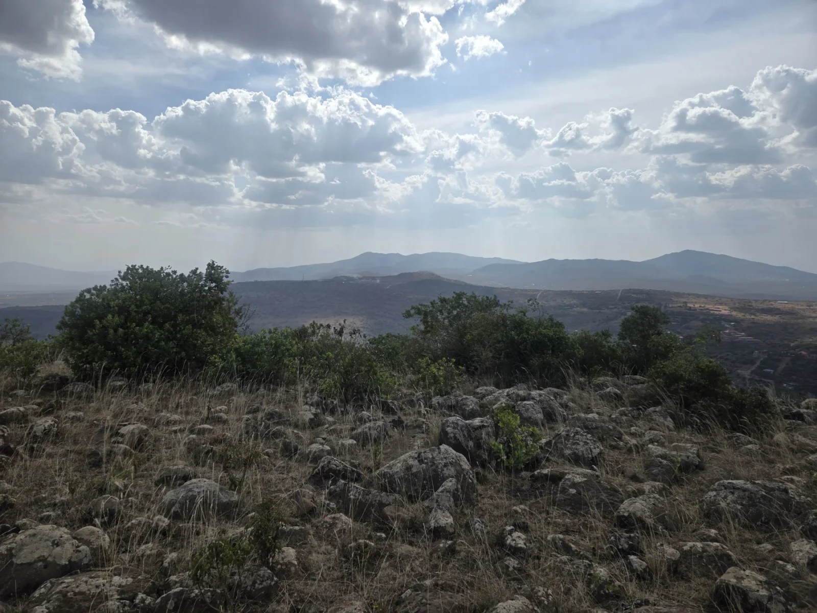 A view of the distant ridgeline from the foreground terrain.